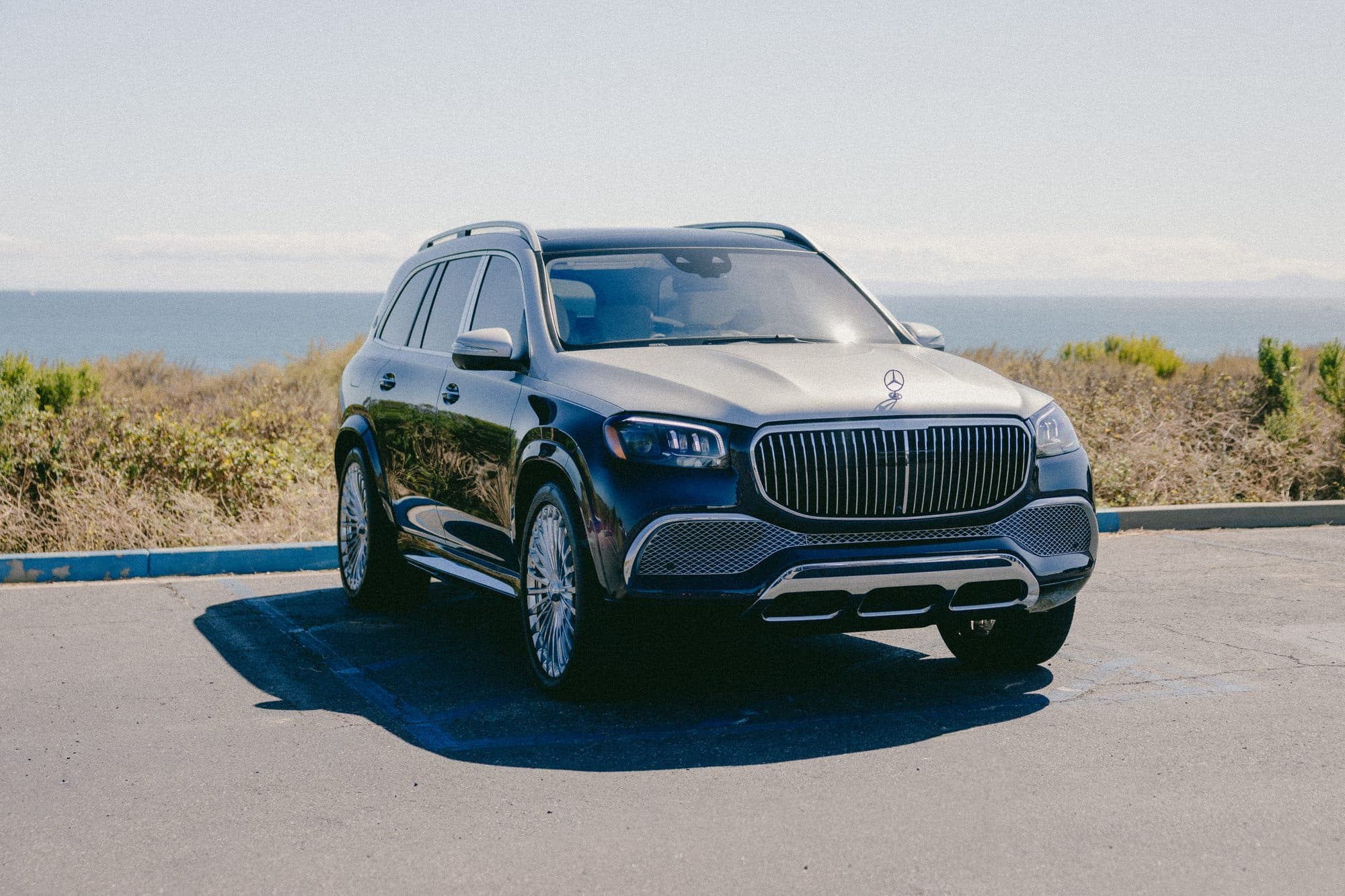 Black Mercedes-Maybach GLS parked above the ocean in Orange County